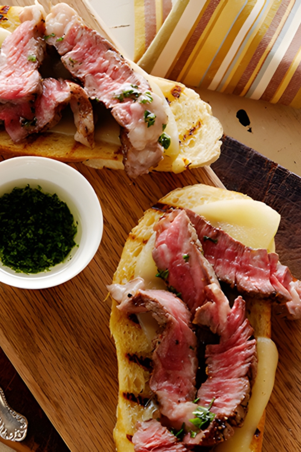 Mini Open Faced Steak Sandwiches on Garlic Bread with Aged Provolone and Parsley Oil