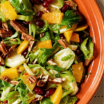 Shaved Brussels Sprouts with Pomegranate Orange Vinaigrette and Pecans